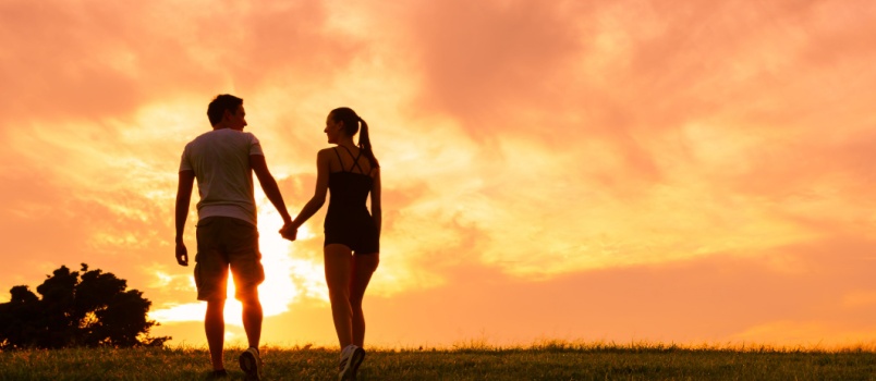 Young couple enjoying beautiful sunset