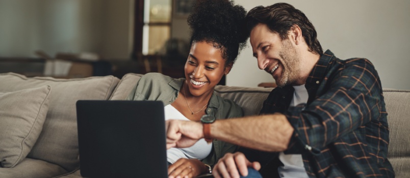 Young couple watching laptop
