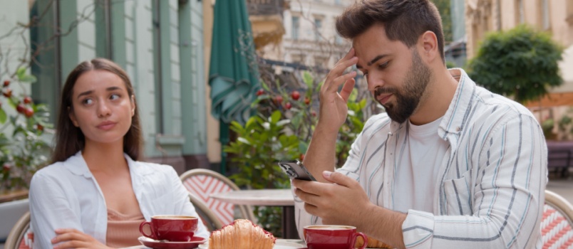 Young couple having breakfast at cafe