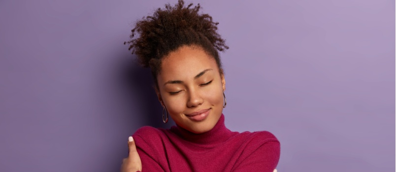 Woman hugging herself