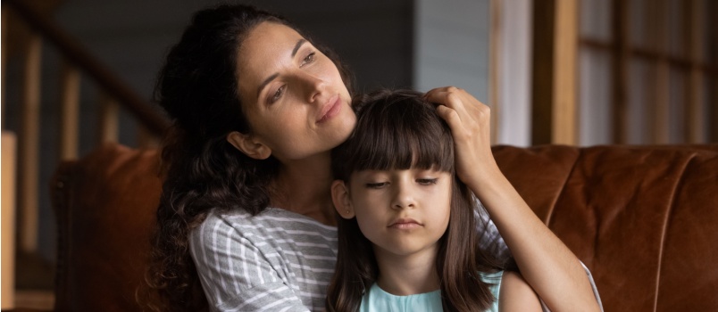 Mother hugging daughter