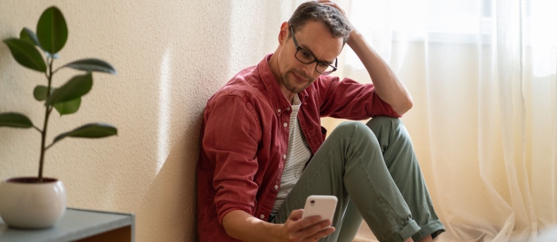 Upset man using smartphone