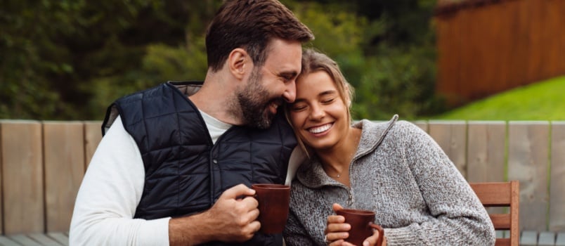 Smiling couple having tea together