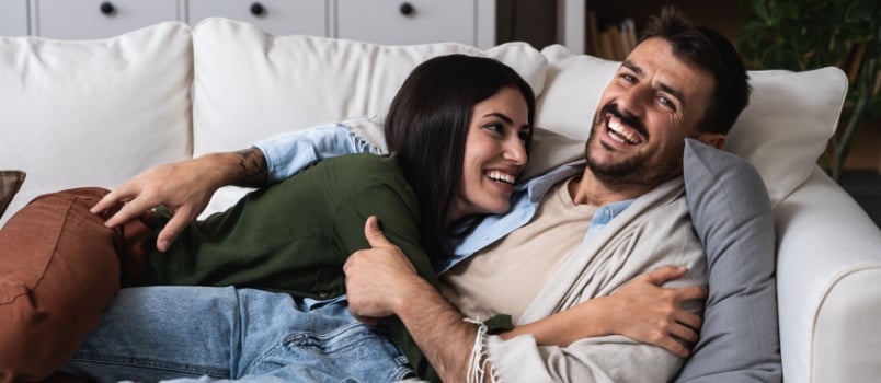 Young couple laying on couch