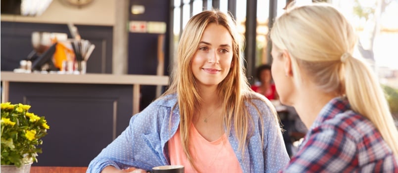 Two female friends talking to each other