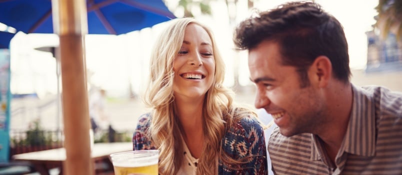 Happy couple enjoying having drinks