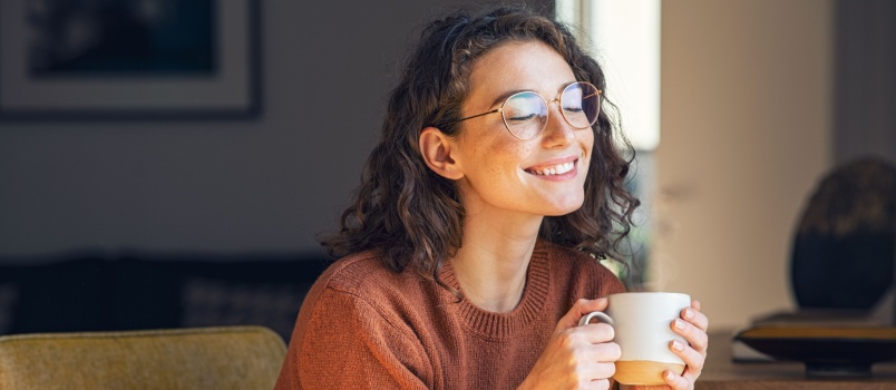 Happy woman drinking coffee