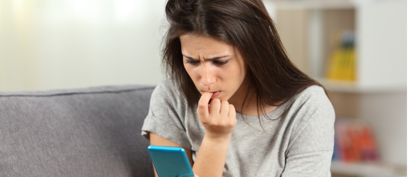 Nervous girl reading text messages