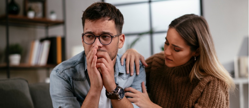 Woman comforting sad man