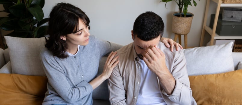 Woman comforting man