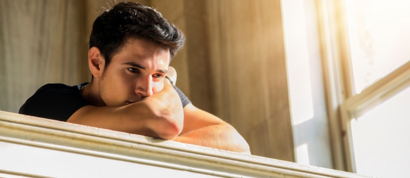 Yean man leaning on window