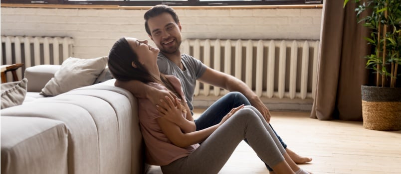 Overenjoyed couple sit on the floor