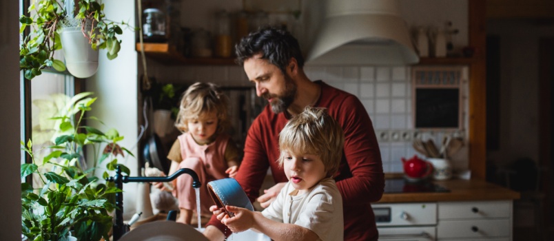 Father washing the utensils with kids