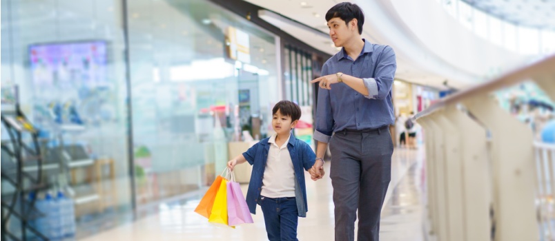 Cheerful son and father walking together