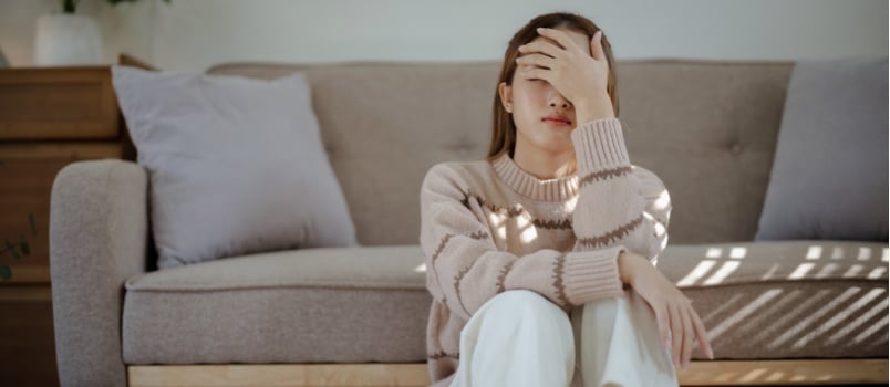 Sad depressed woman sitting on floor