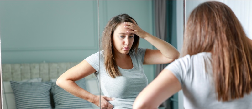 Young woman touching her belly