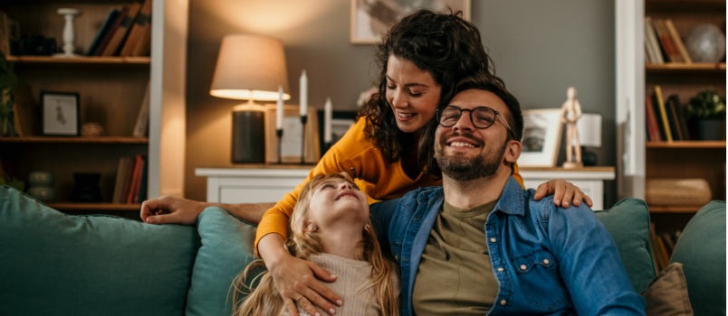 Parents and kid relaxing on couch