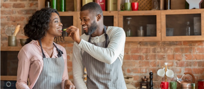 Man feeding woman