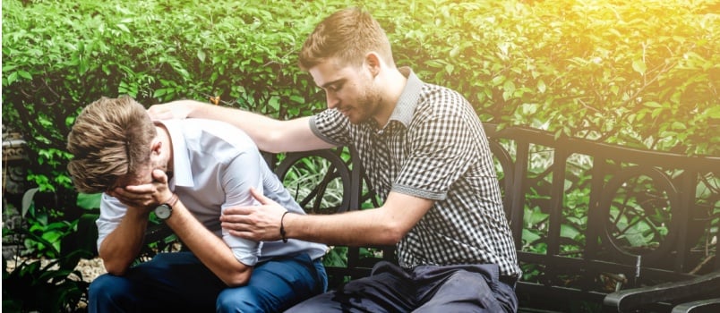 Man consoling another man