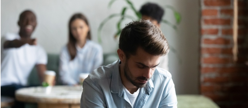 Upset man suffering gossiping