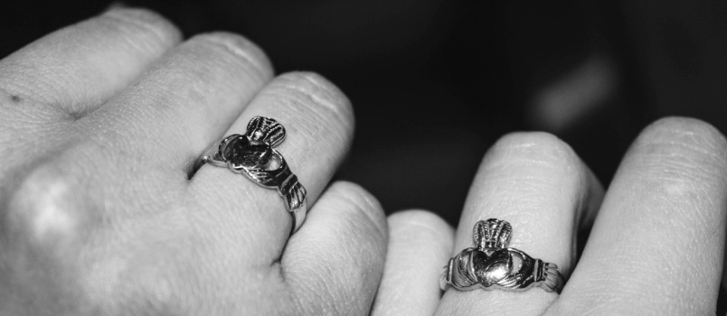 Two hands wearing claddagh ring