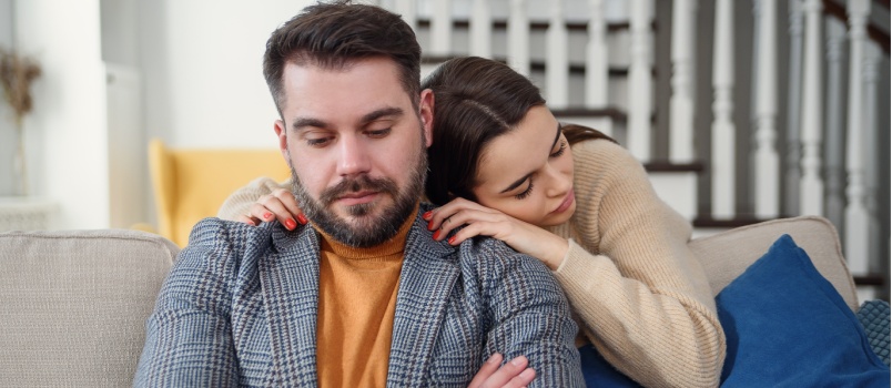 Wife comforting sad husband