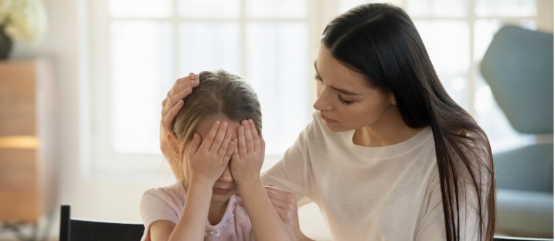 Caring mother hugging her daughter