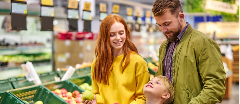 Parents doing grocery shopping with kid
