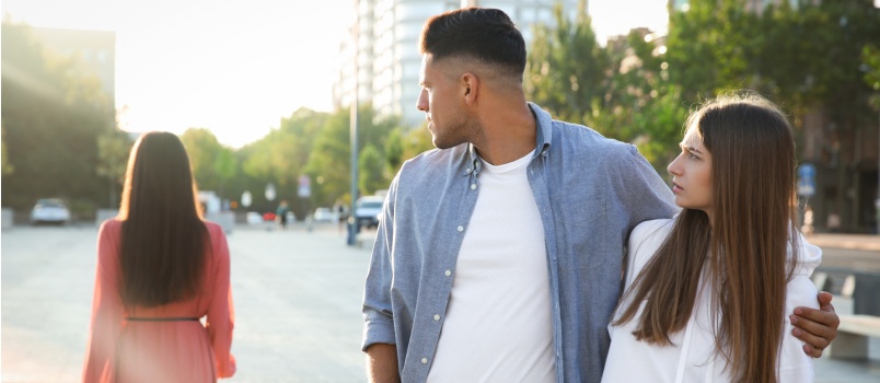 Man looking at another woman