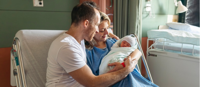 Couple holding new born baby