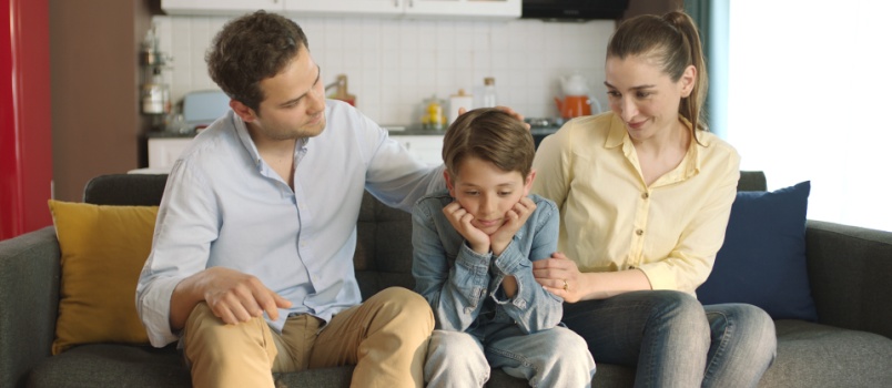 Couple comforting their sad kid
