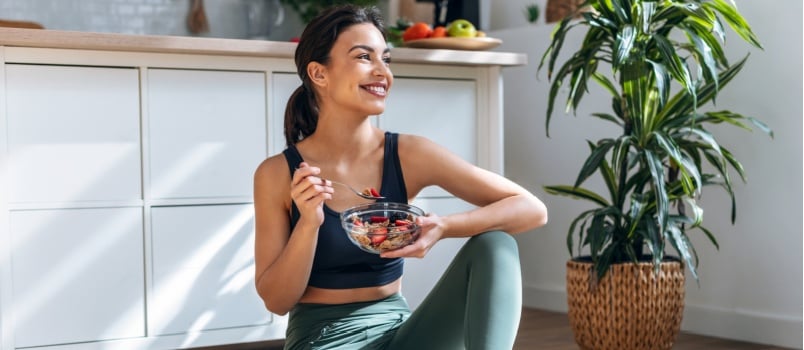 Woman eating healthy bowl