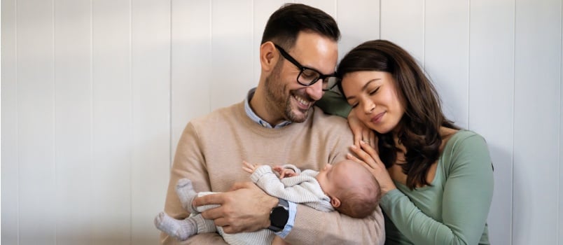 Happy couple holding baby