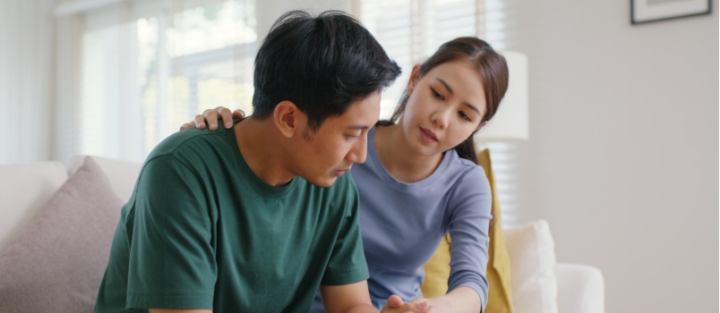 Woman comforting sad man
