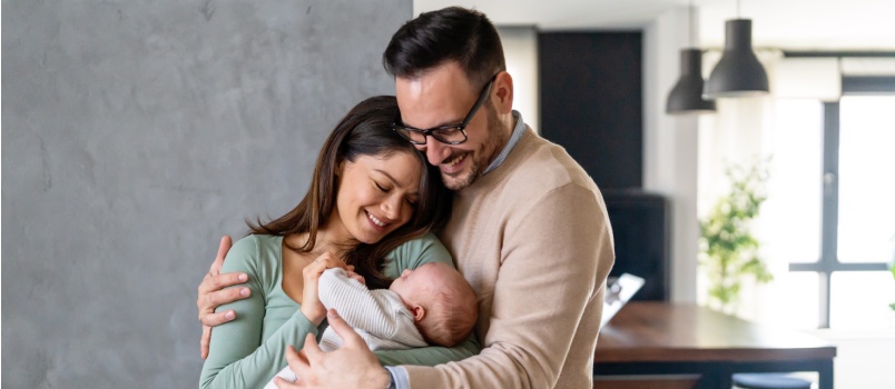 Young married couple holding baby