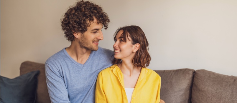 Young happy couple holding hands