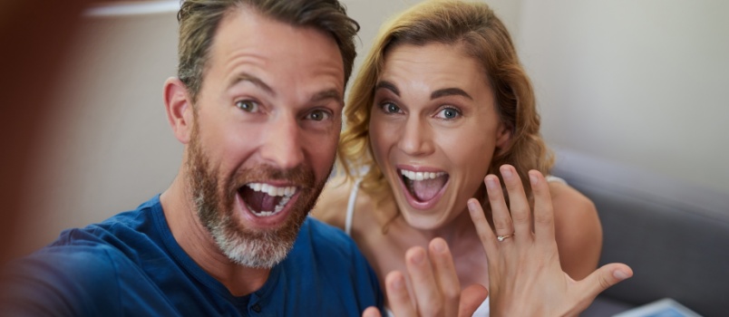 Young couple showing their wedding rings