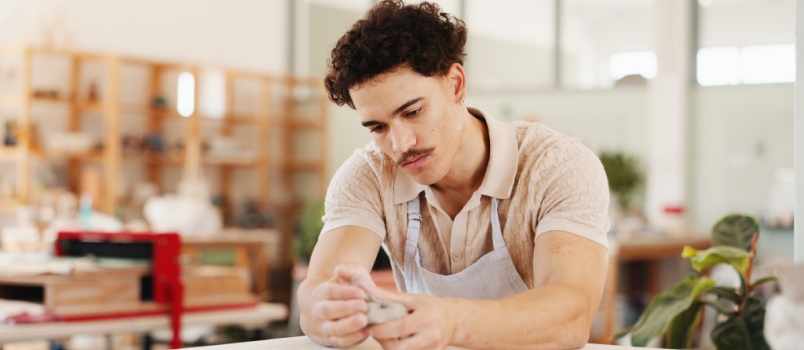 Man making design with clay