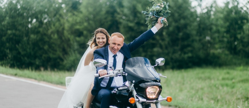Bride and groom on bike