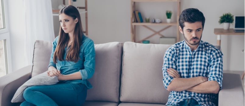 Couple sitting apart from each other