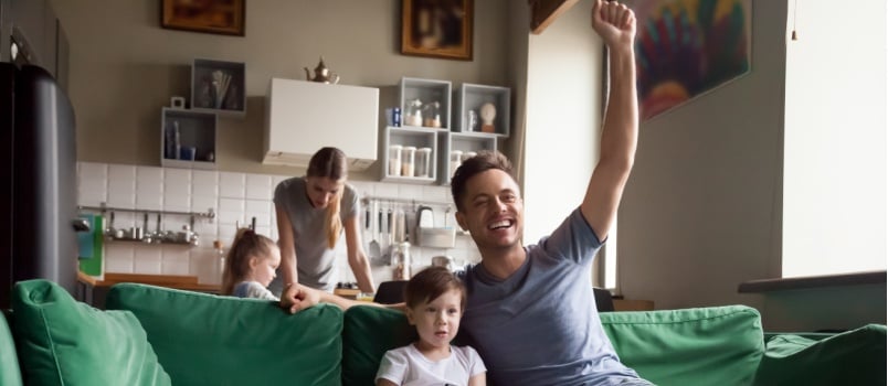 Son father watching football match
