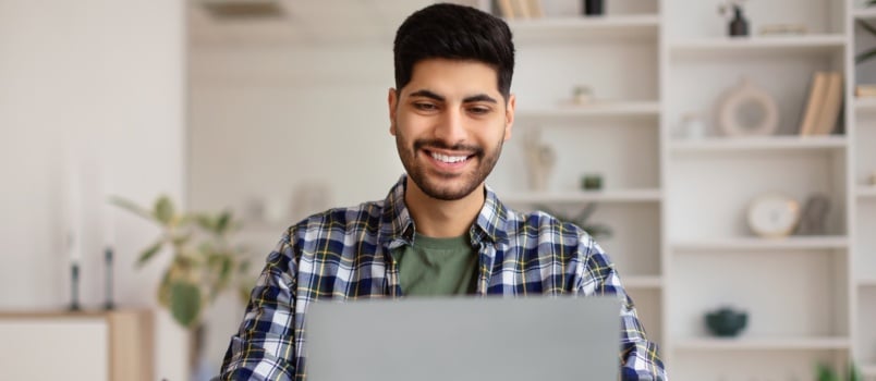 Smiling man working laptop