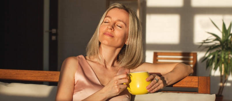 Woman relaxing couch having coffee