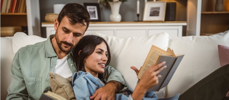 Adult couple relaxing and reading book 