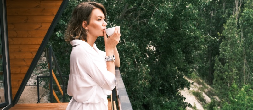 Young beauty drinking tea or coffee