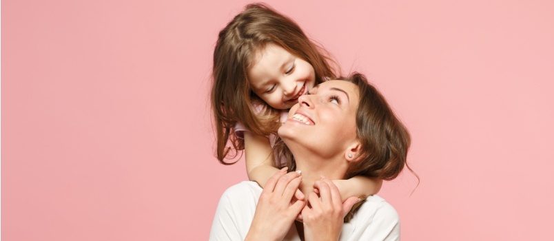 Daughter cuddling with mother