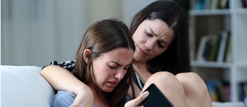 mother comforting sad teen