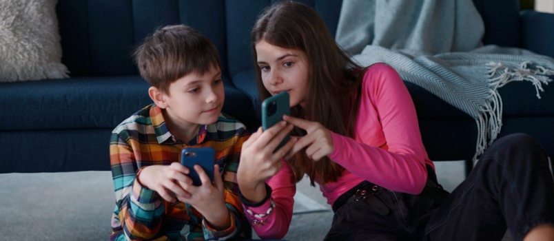Addorable teen using smartphone