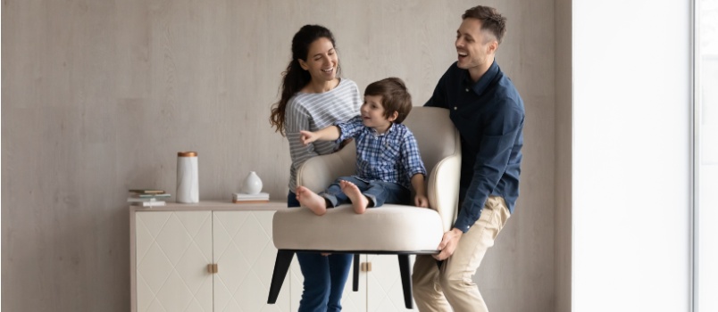 Happy funny parents holding cheerful baby