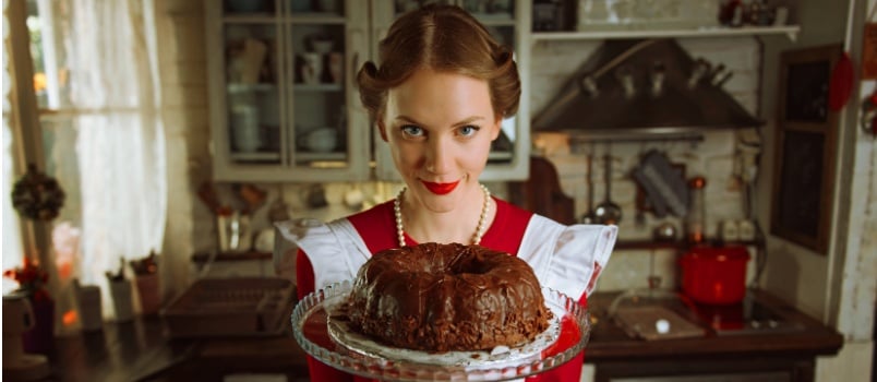 housewife holding chocolate cake 